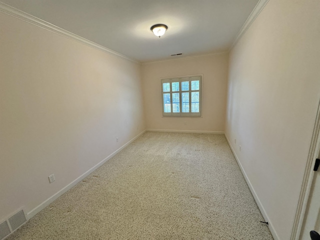 empty room featuring crown molding and light carpet