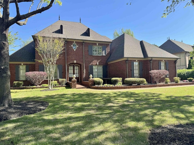 view of front of property with french doors and a front lawn