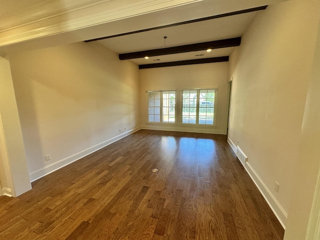 empty room with beam ceiling and dark hardwood / wood-style flooring