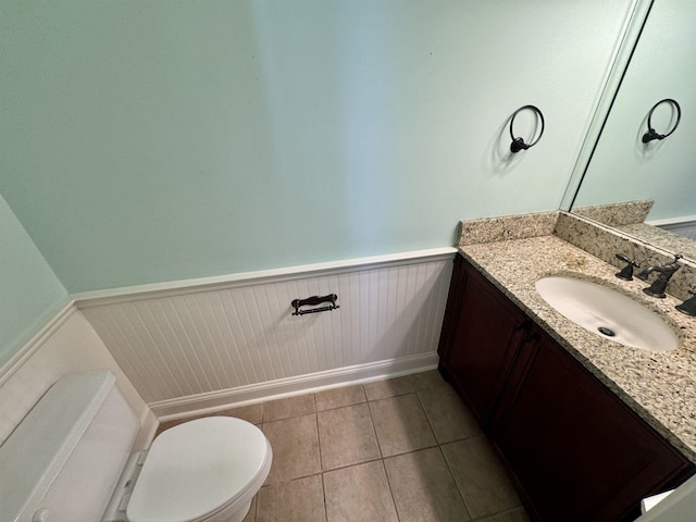 bathroom featuring tile patterned floors, vanity, and toilet