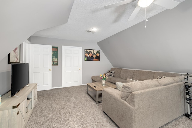 carpeted living room with ceiling fan, a textured ceiling, and vaulted ceiling