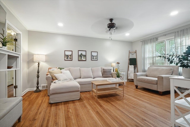 living room featuring ceiling fan, light hardwood / wood-style floors, and ornamental molding