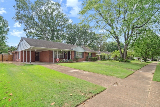 ranch-style home featuring a carport and a front yard