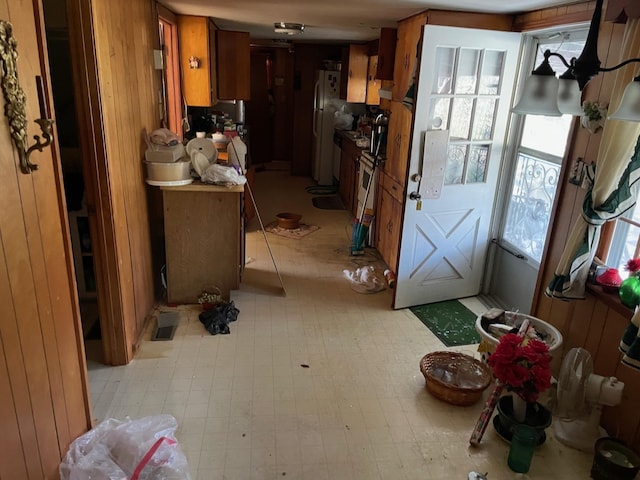 kitchen with wood walls and white fridge