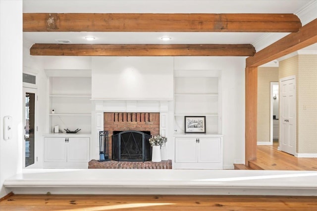 unfurnished living room with built in shelves, a fireplace, and hardwood / wood-style floors