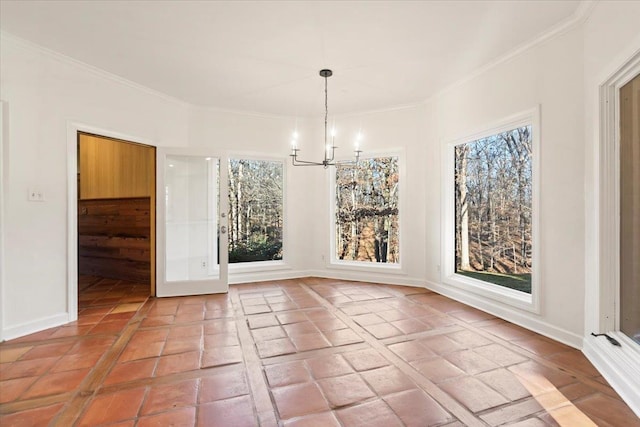 unfurnished dining area with plenty of natural light, crown molding, and an inviting chandelier