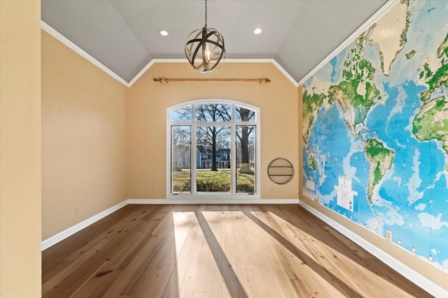 unfurnished room featuring hardwood / wood-style floors, crown molding, and vaulted ceiling