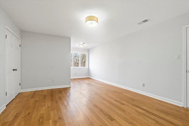 unfurnished room with light wood-type flooring