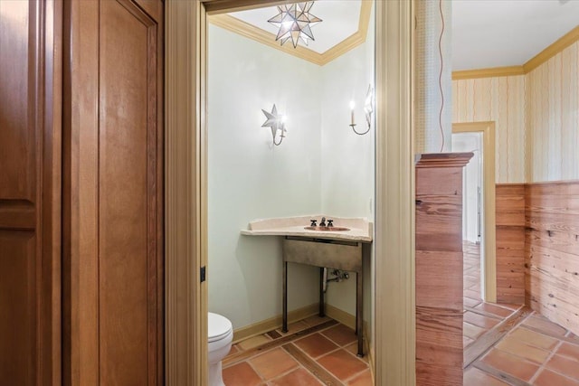 bathroom with toilet and ornamental molding