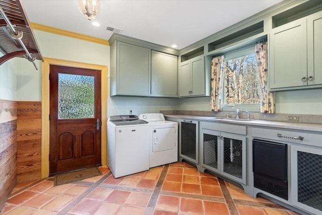 laundry area with sink, cabinets, washer and clothes dryer, light tile patterned flooring, and ornamental molding