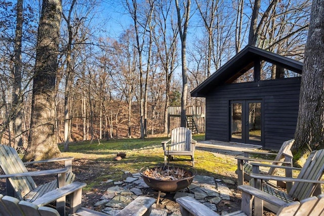 view of yard with french doors and a fire pit