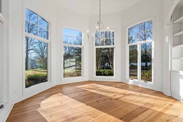 unfurnished sunroom with a chandelier