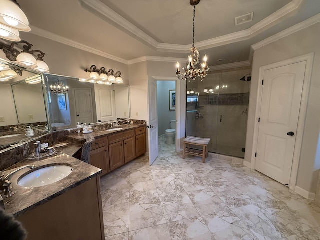 bathroom featuring a raised ceiling, crown molding, toilet, vanity, and a shower with shower door