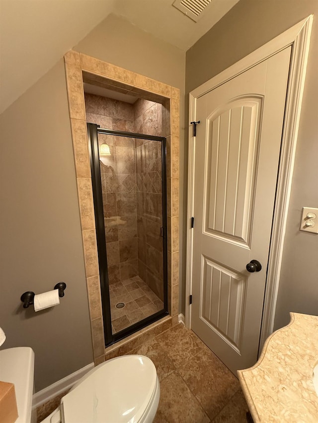 bathroom featuring vanity, toilet, and an enclosed shower