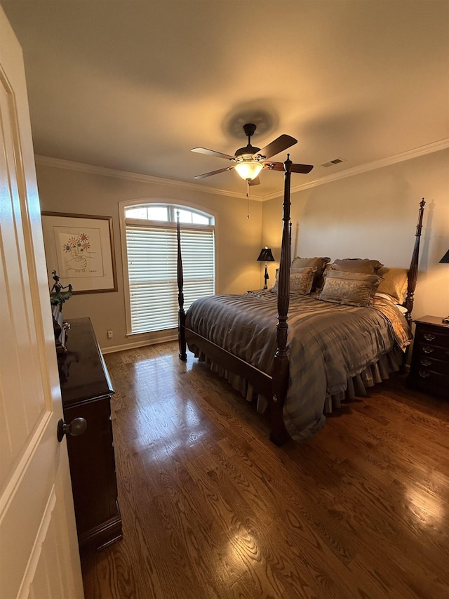 bedroom featuring dark hardwood / wood-style floors, ceiling fan, and ornamental molding