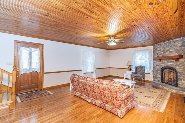 living room with a fireplace, ceiling fan, hardwood / wood-style floors, and wooden ceiling