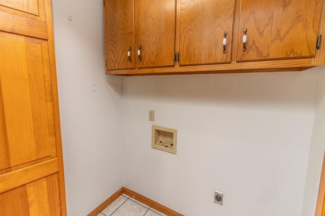 laundry room featuring cabinets, hookup for a washing machine, light tile patterned floors, and hookup for an electric dryer