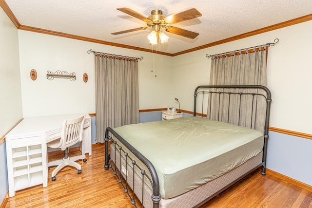 bedroom with light hardwood / wood-style floors, ceiling fan, and crown molding