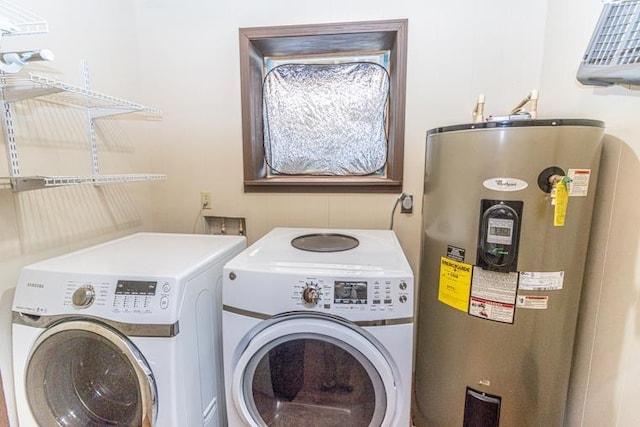 clothes washing area with washing machine and dryer and electric water heater