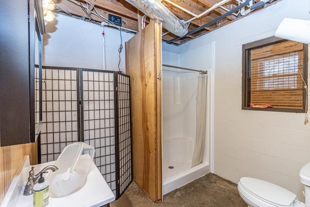 bathroom with toilet, vanity, concrete flooring, and a shower with shower curtain