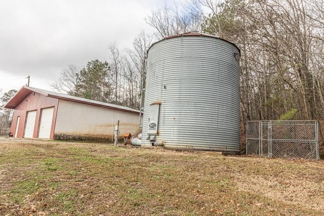 view of outdoor structure featuring a lawn and a garage