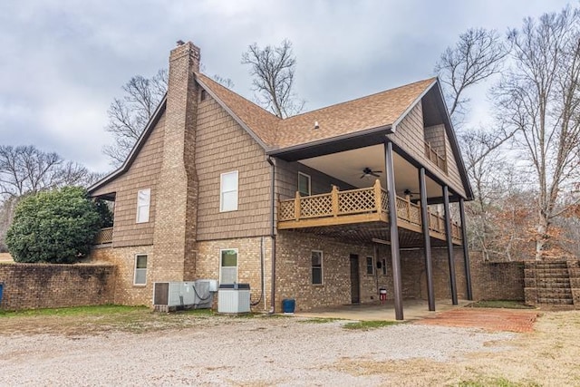 rear view of house featuring a patio area, ceiling fan, cooling unit, and a wooden deck