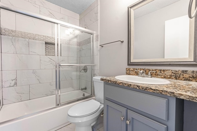 full bathroom with vanity, toilet, enclosed tub / shower combo, and a textured ceiling