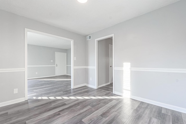 spare room with hardwood / wood-style floors