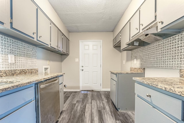 kitchen featuring tasteful backsplash, dishwasher, dark hardwood / wood-style floors, and a textured ceiling