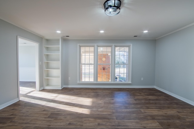 spare room featuring built in shelves, dark hardwood / wood-style floors, and ornamental molding