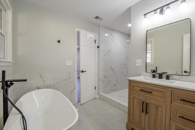 bathroom with vanity, tile walls, and plus walk in shower