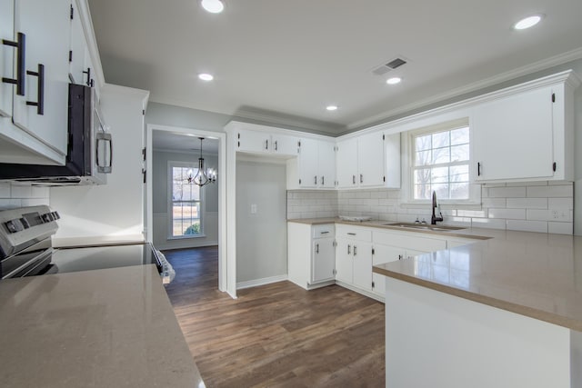 kitchen with white cabinetry, range, and sink