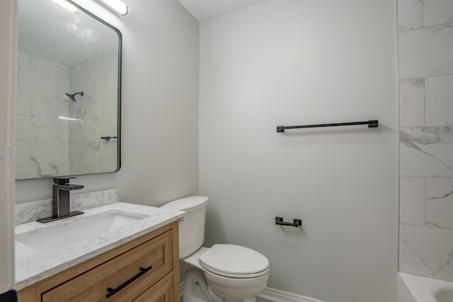 full bathroom featuring vanity, tiled shower / bath combo, and toilet