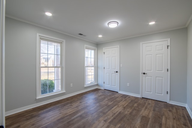 unfurnished bedroom with dark wood-type flooring and ornamental molding