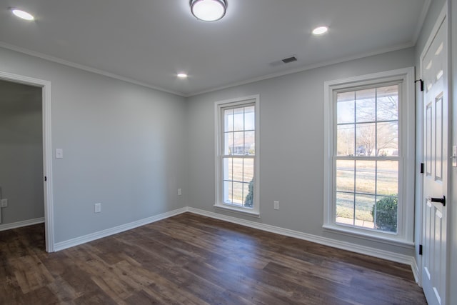 spare room with dark hardwood / wood-style flooring and ornamental molding