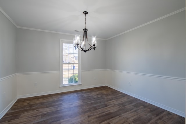 spare room featuring a chandelier, dark hardwood / wood-style flooring, and ornamental molding