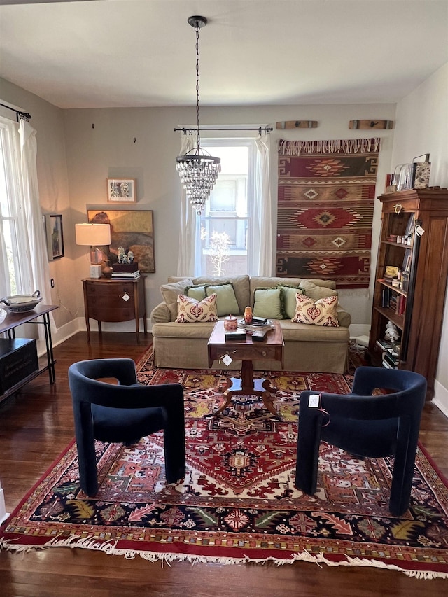 living room with a chandelier and dark hardwood / wood-style floors