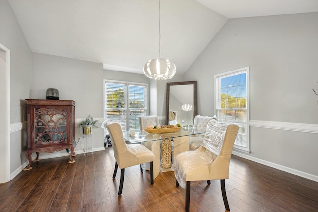 dining space featuring dark hardwood / wood-style flooring, vaulted ceiling, and a notable chandelier