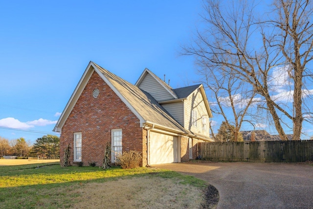 view of home's exterior featuring a garage and a yard