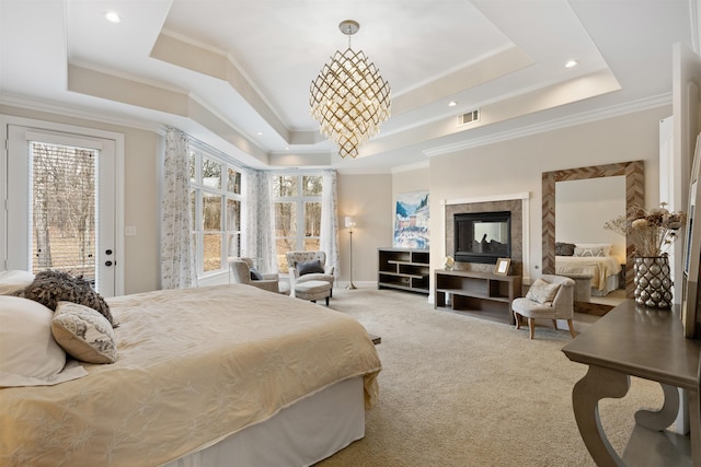 bedroom featuring access to exterior, carpet, a tray ceiling, crown molding, and an inviting chandelier