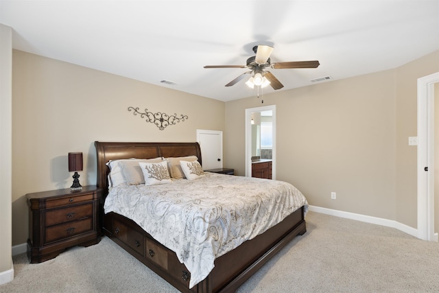 carpeted bedroom featuring ceiling fan and ensuite bath