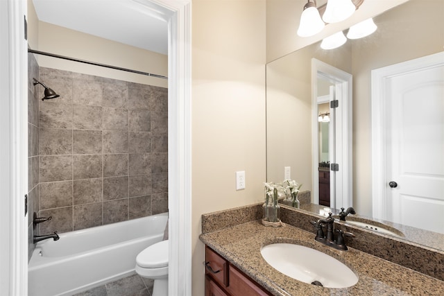 full bathroom with vanity, toilet, and tiled shower / bath