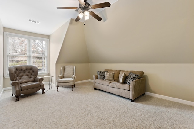 living area featuring ceiling fan, light colored carpet, and vaulted ceiling