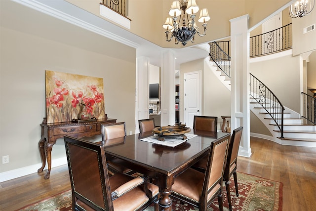 dining room with dark hardwood / wood-style floors, a high ceiling, and a chandelier