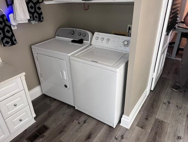 washroom featuring washer and clothes dryer and dark hardwood / wood-style floors