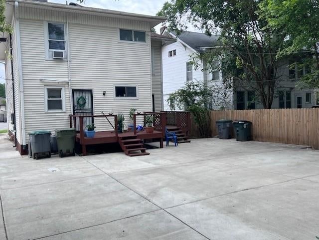 rear view of house with a patio area and a wooden deck