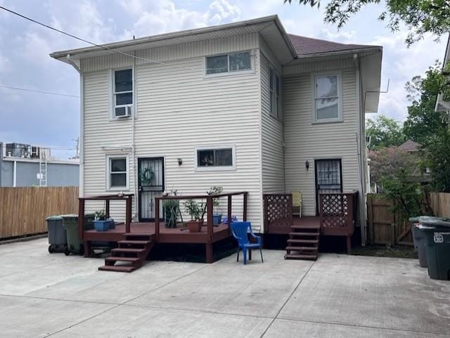 rear view of house featuring a patio and a deck