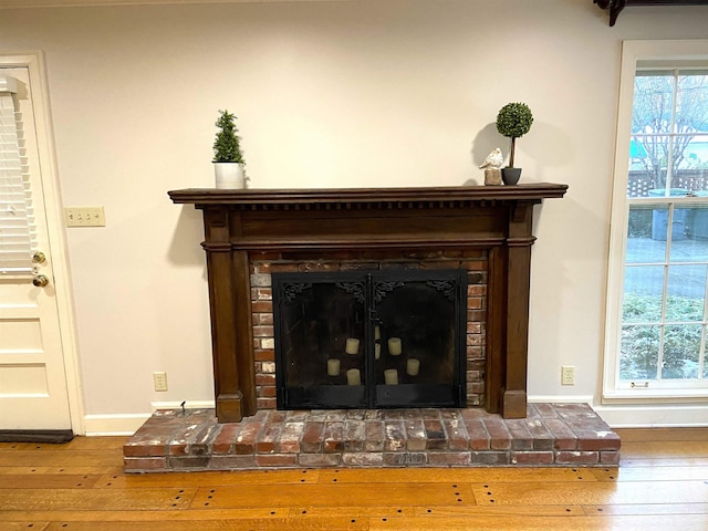 interior details featuring a fireplace and wood-type flooring