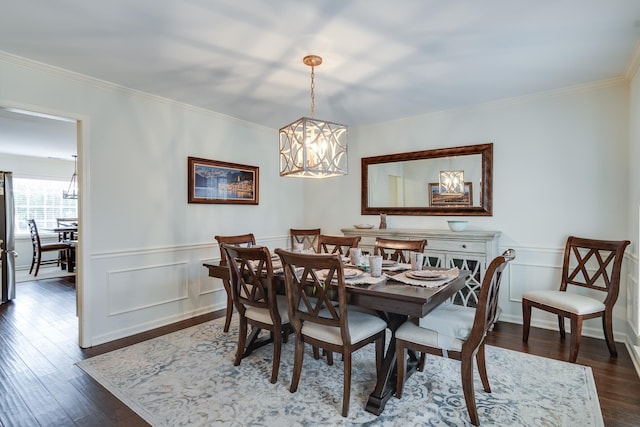 dining space with dark hardwood / wood-style floors and a chandelier