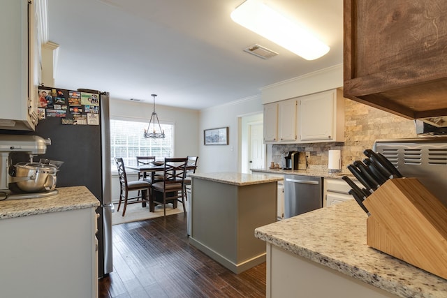 kitchen featuring tasteful backsplash, light stone counters, stainless steel appliances, a center island, and hanging light fixtures